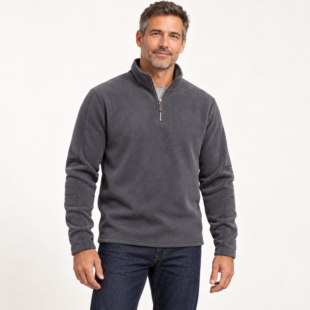 Man wearing the charcoal quarter zip fleece pullover with dark jeans