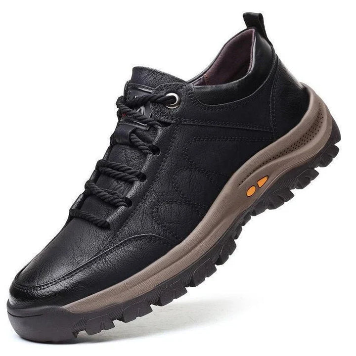 Black trail walking shoe with lace up front and thick lug sole, side view