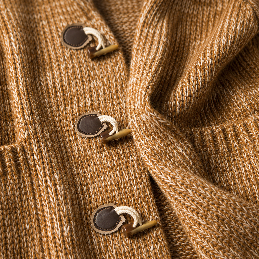 Detail of three horn toggle buttons on the camel chunky knit cardigan