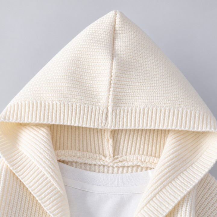 Close-up of the ivory knit hood and ribbed neckline