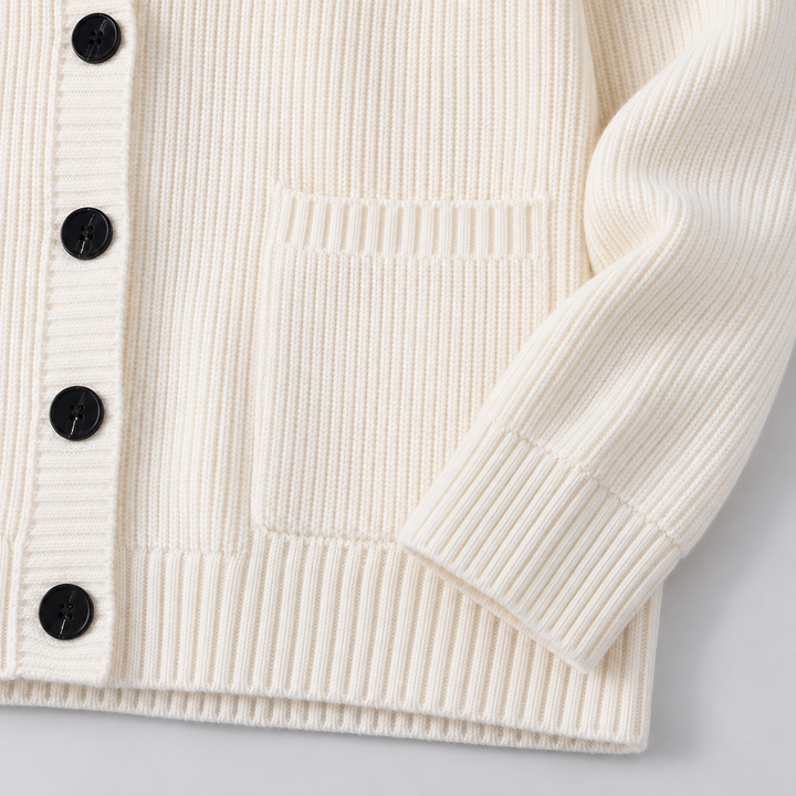 Ivory hooded cardigan hem showing the front pocket, buttons and ribbed cuff