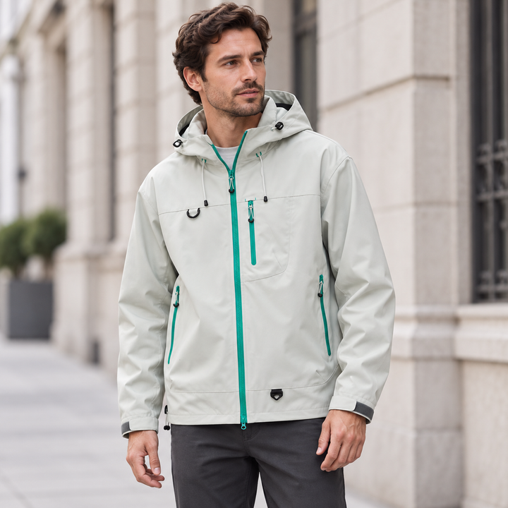 Light gray hooded jacket worn on a city street with a teal zipper
