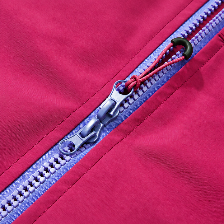 Close-up of the purple two way zipper and pull on the raspberry jacket