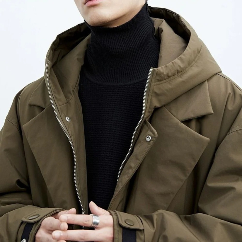 Close view of the olive parka hood, zip front and button placket