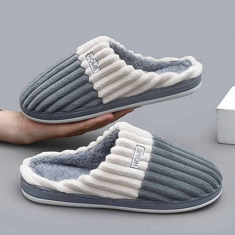 Slate gray ribbed slippers shown with a hand holding the pair
