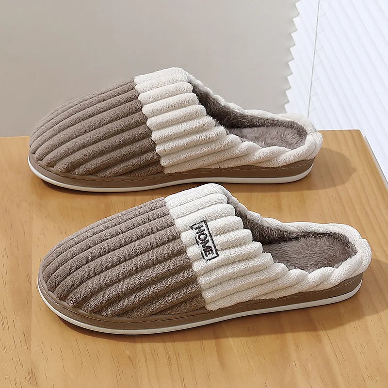 Taupe ribbed slip-on slippers with cream cuff on a wooden table