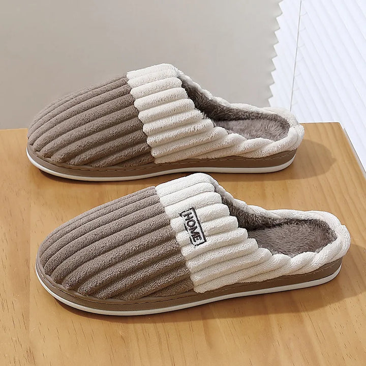 Taupe ribbed slip-on slippers with cream cuff on a wooden table