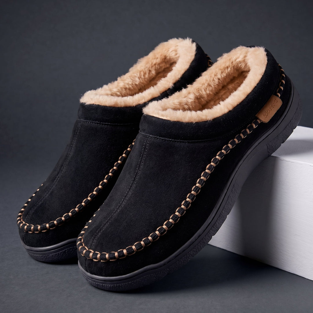 Pair of black moccasin slippers with faux fur lining and stitched trim