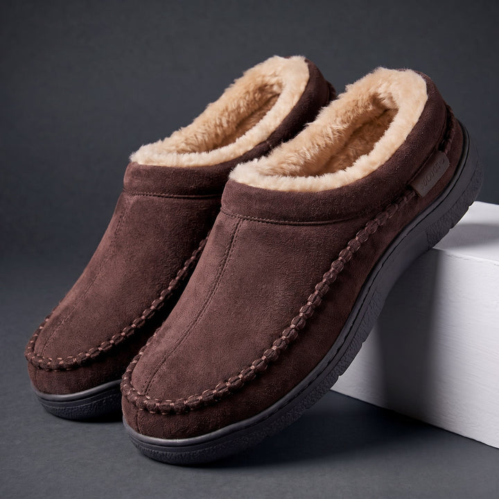 Pair of chocolate brown moccasin slippers with faux fur lining