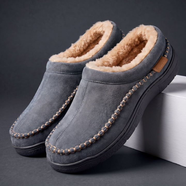 Pair of gray moccasin slippers with faux fur lining