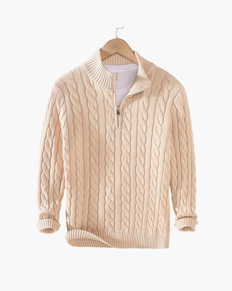 Beige cable knit quarter zip pullover on a hanger