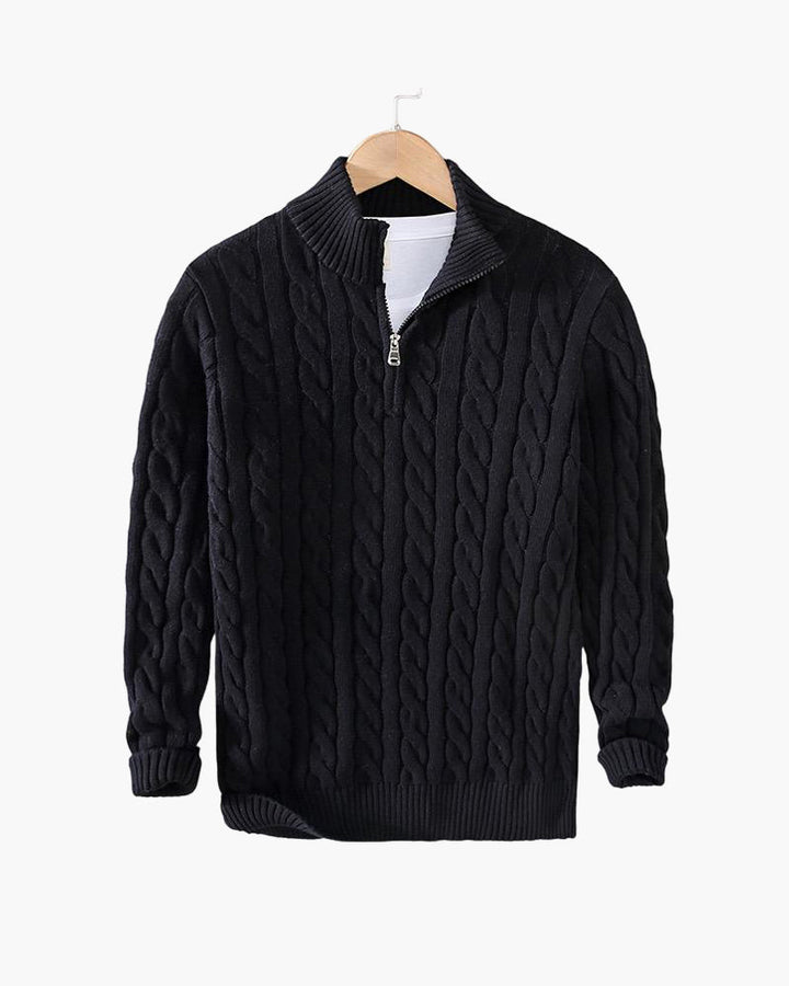 Black cable knit quarter zip pullover on a hanger