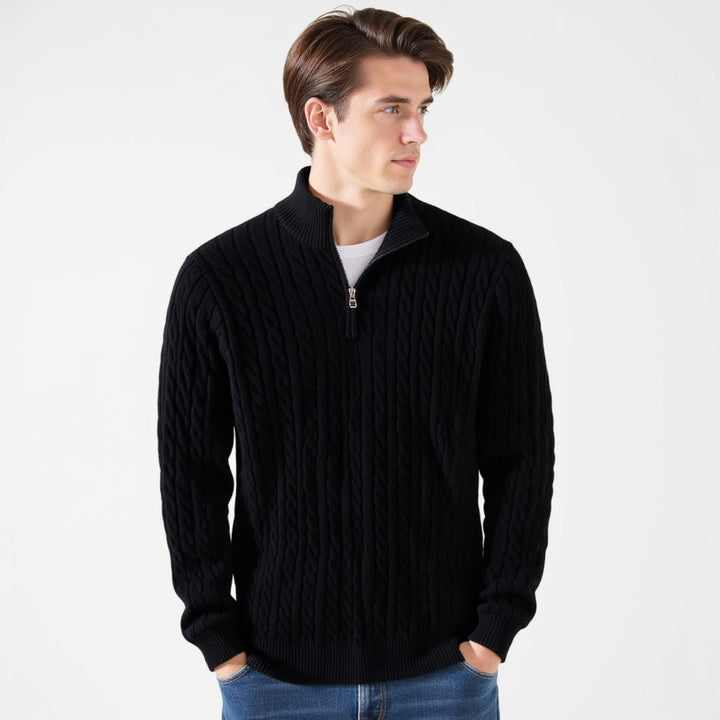 Man wearing a black cable knit quarter zip pullover, front view