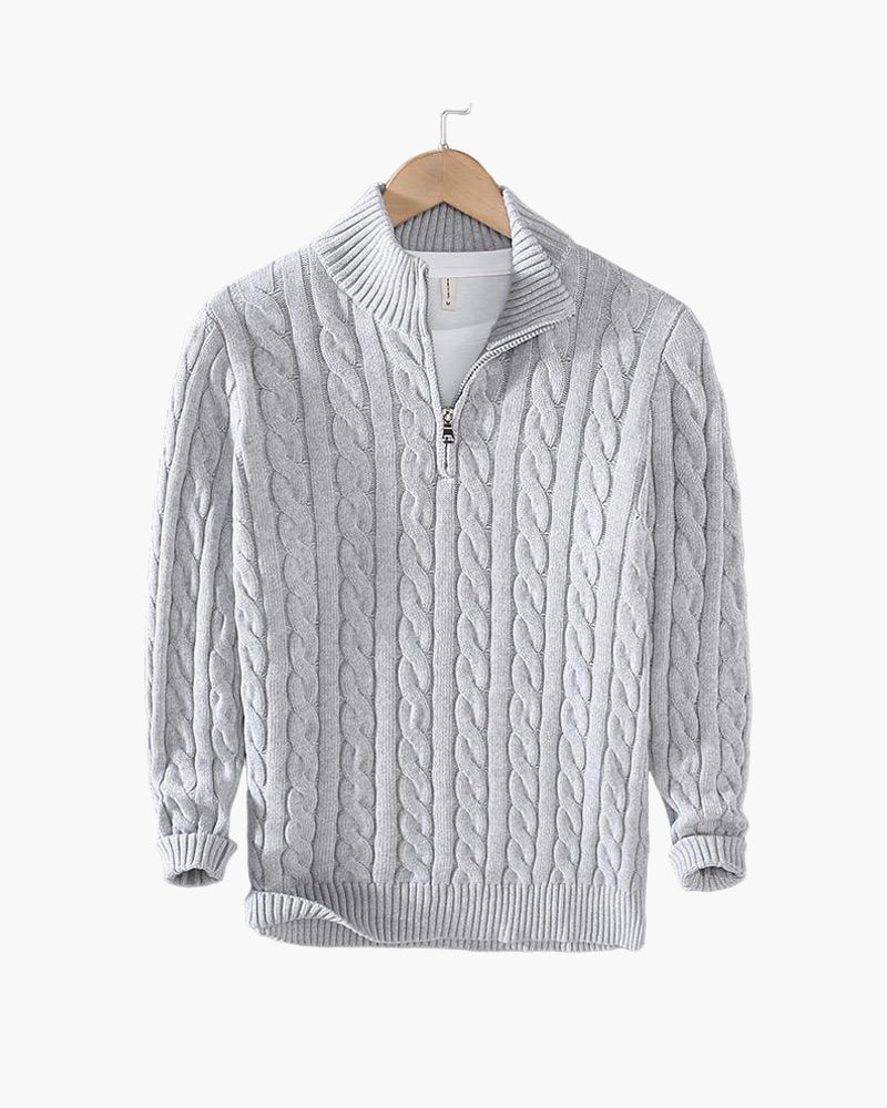 Gray cable knit quarter zip pullover on a hanger