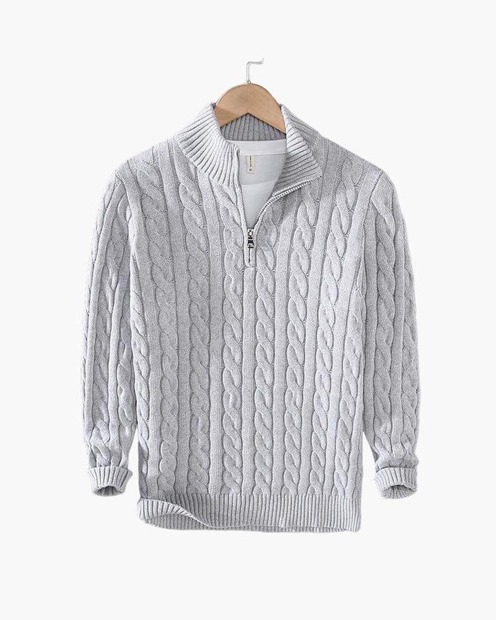 Gray cable knit quarter zip pullover on a hanger