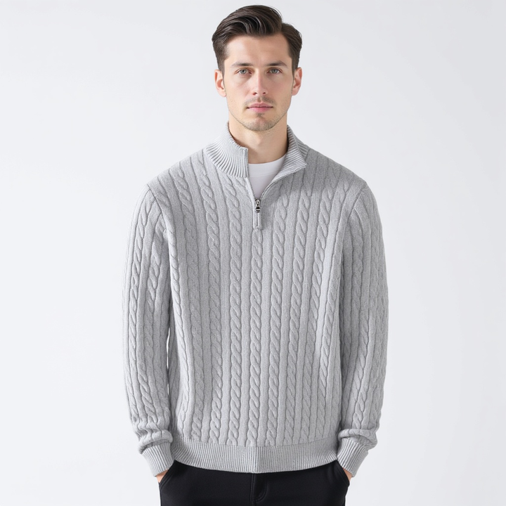 Man wearing a gray cable knit quarter zip pullover, front view