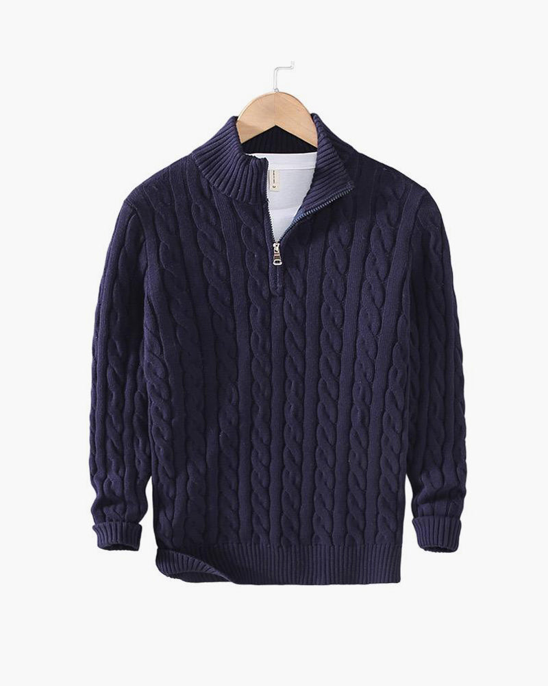 Navy cable knit quarter zip pullover on a hanger
