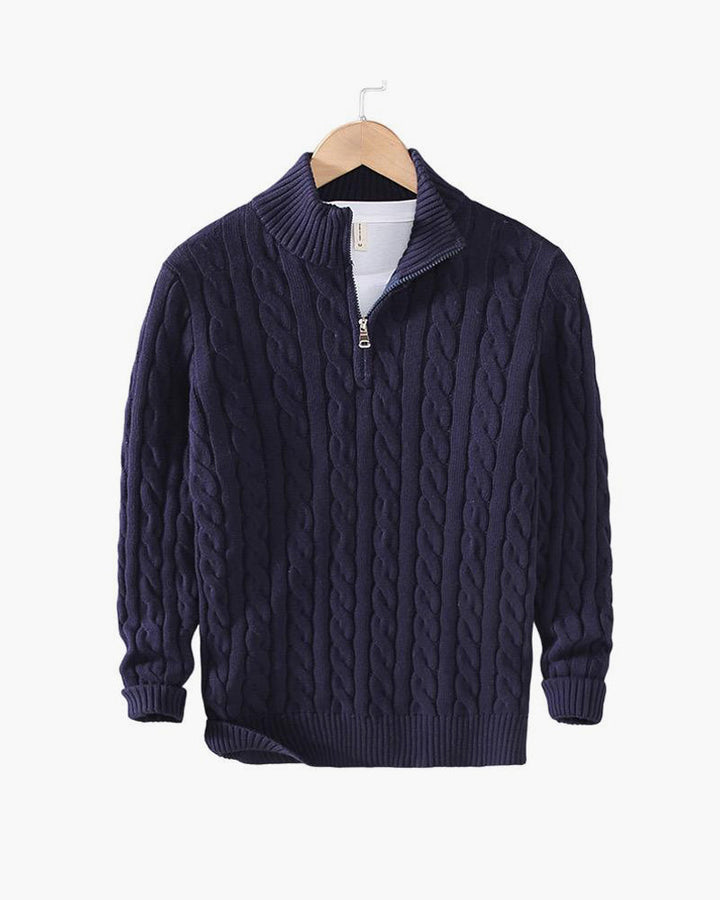 Navy cable knit quarter zip pullover on a hanger