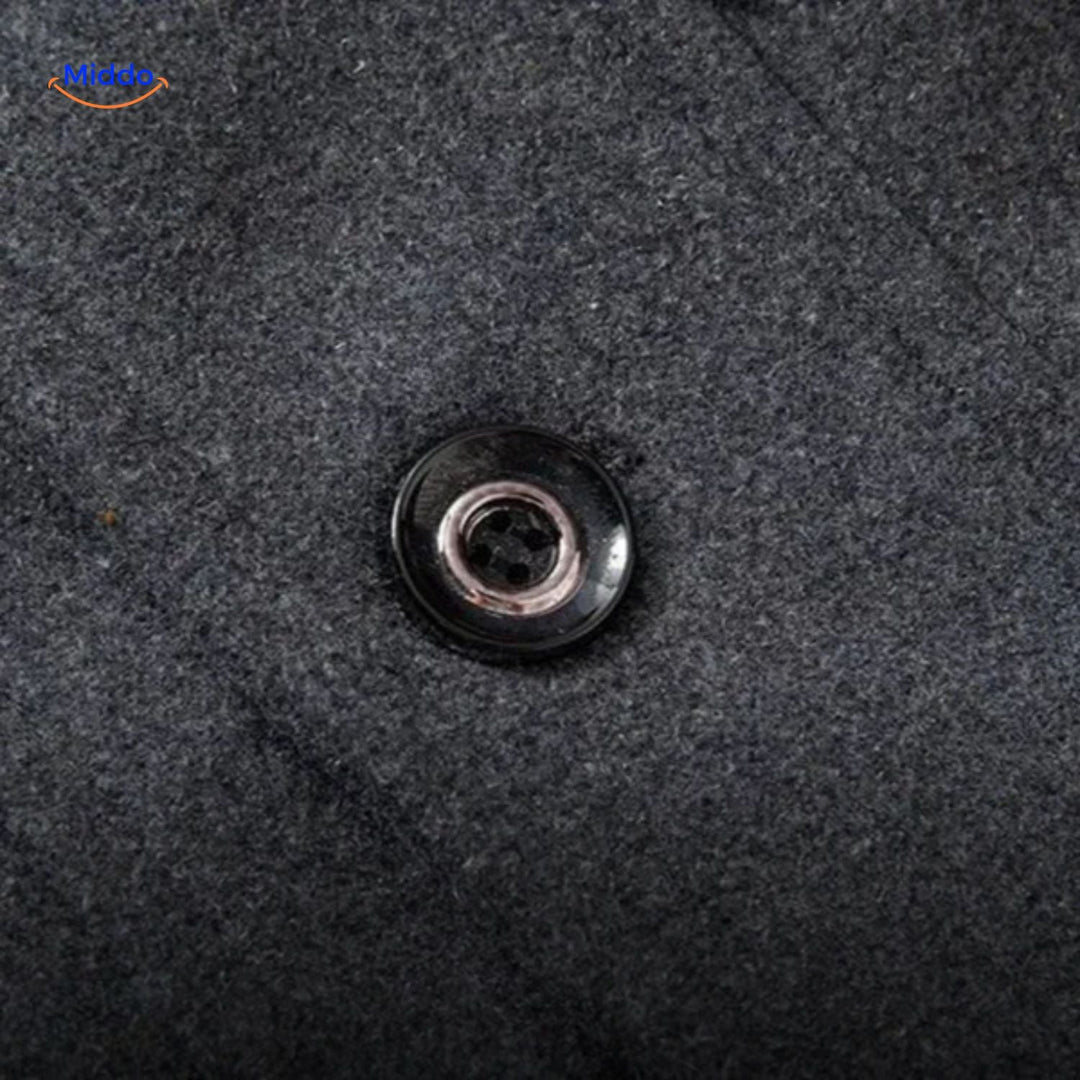 Close-up of a metal button on the gray overcoat&