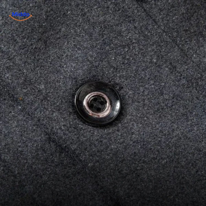 Close-up of a metal button on the gray overcoat&