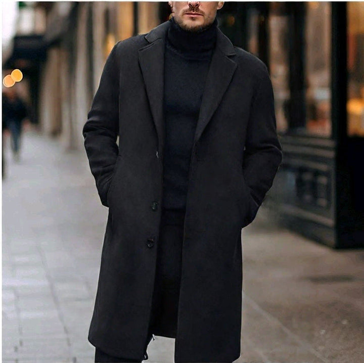 Black knee-length overcoat on a city street