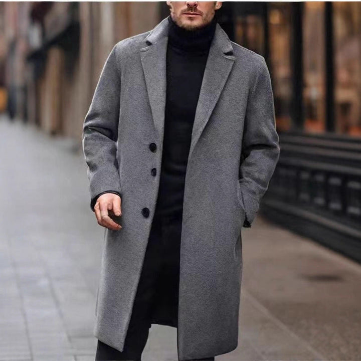 Dark gray long overcoat worn over a black turtleneck