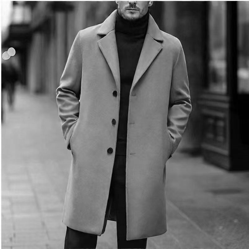 Light gray single breasted overcoat with hands in pockets