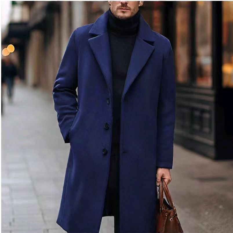 Navy long overcoat with notch lapels and a brown bag