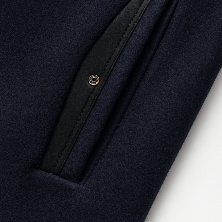 Slanted welt pocket with trim on the navy overcoat