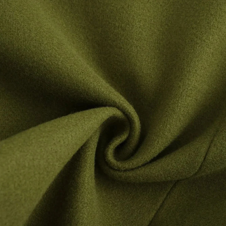 Close up of the olive green coat fabric in a soft swirl