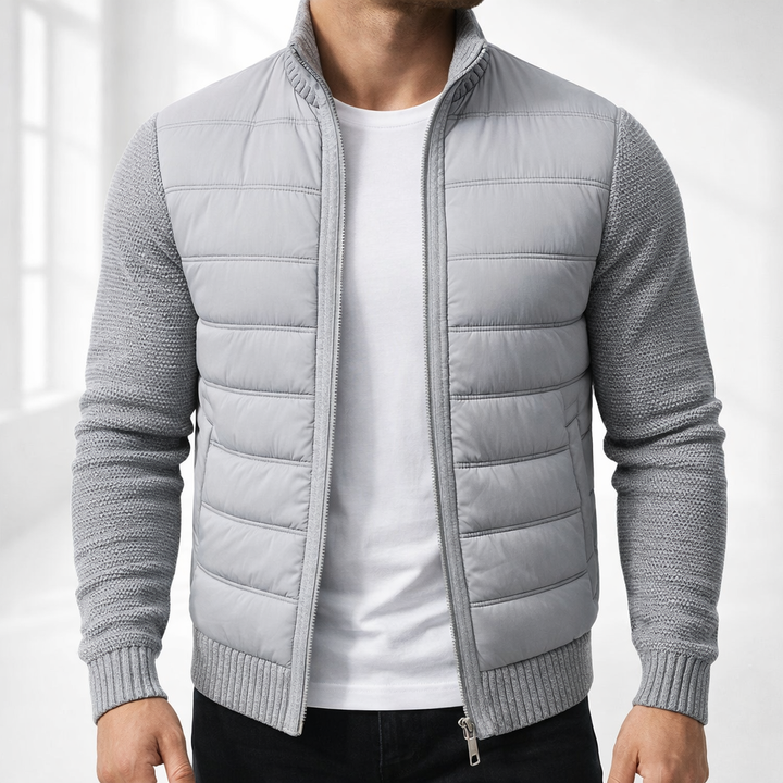 Light gray quilted zip up jacket with knit sleeves and ribbed hem, studio front view