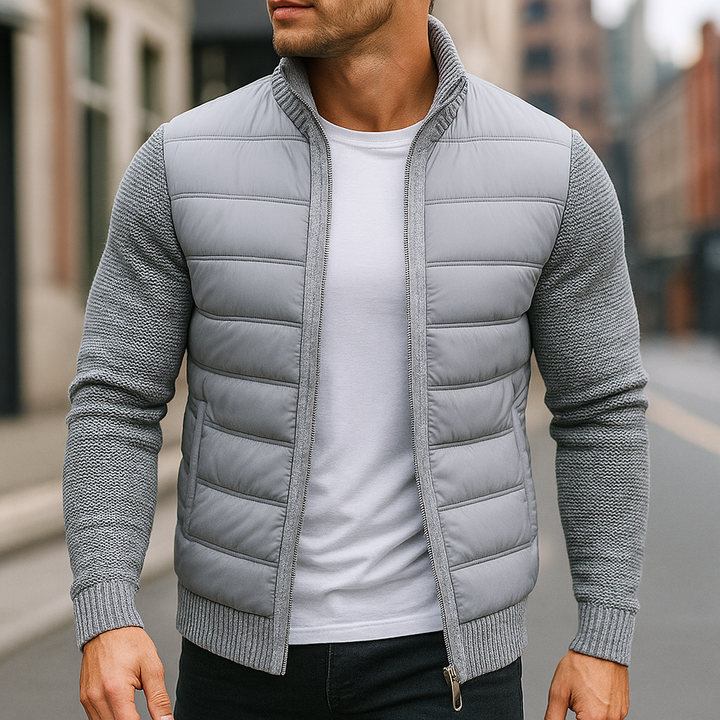 Man wearing the light gray quilted zip up jacket with knit sleeves on a street