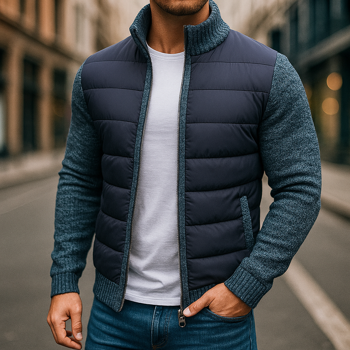 Man wearing the navy quilted zip up jacket with blue knit sleeves, front view
