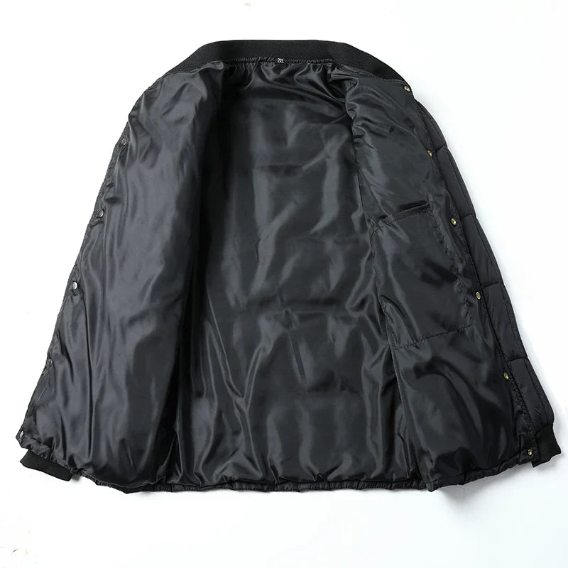 Black puffer jacket laid open to show the inner lining and ribbed cuffs