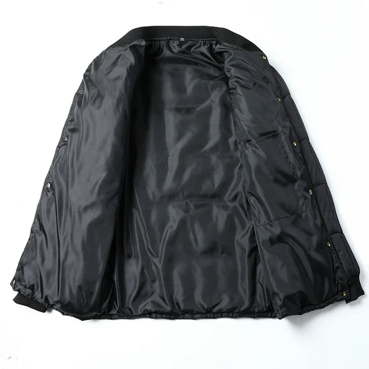 Black puffer jacket laid open to show the inner lining and ribbed cuffs