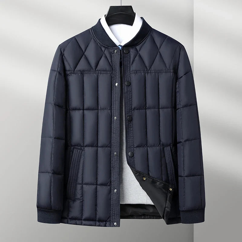 Navy padded quilted puffer jacket with snap front and ribbed collar, flat front view