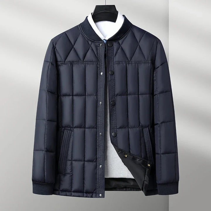 Navy padded quilted puffer jacket with snap front and ribbed collar, flat front view