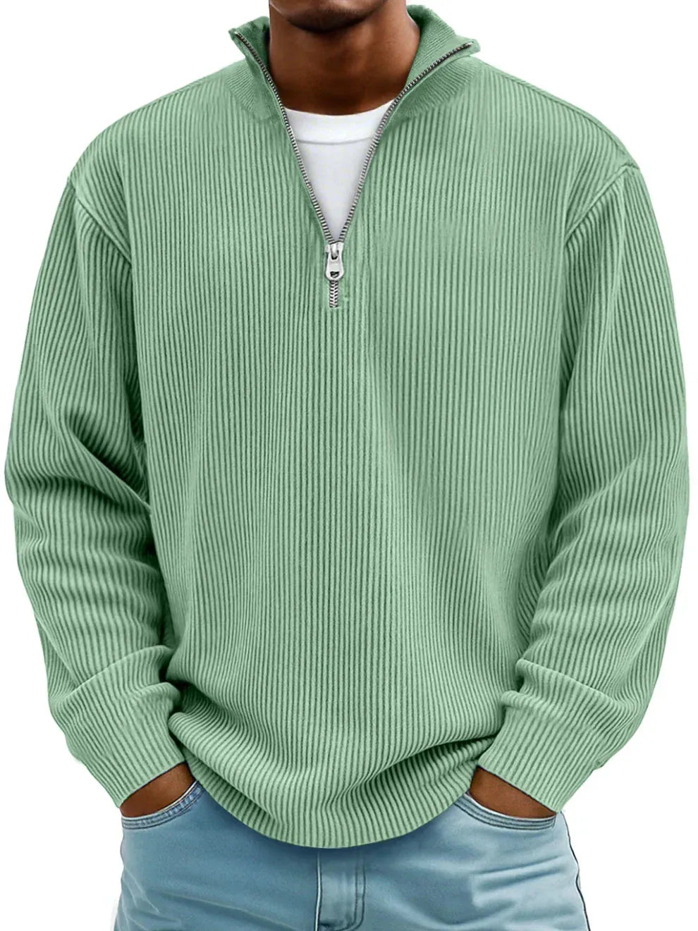 Ribbed Sage Green quarter zip sweater, model with hands in jeans pockets