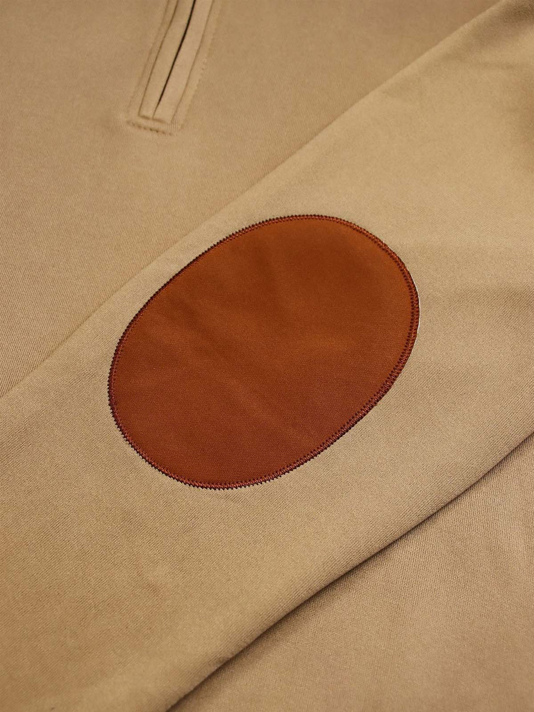 Close up of the orange-brown elbow patch on the khaki quarter zip sleeve