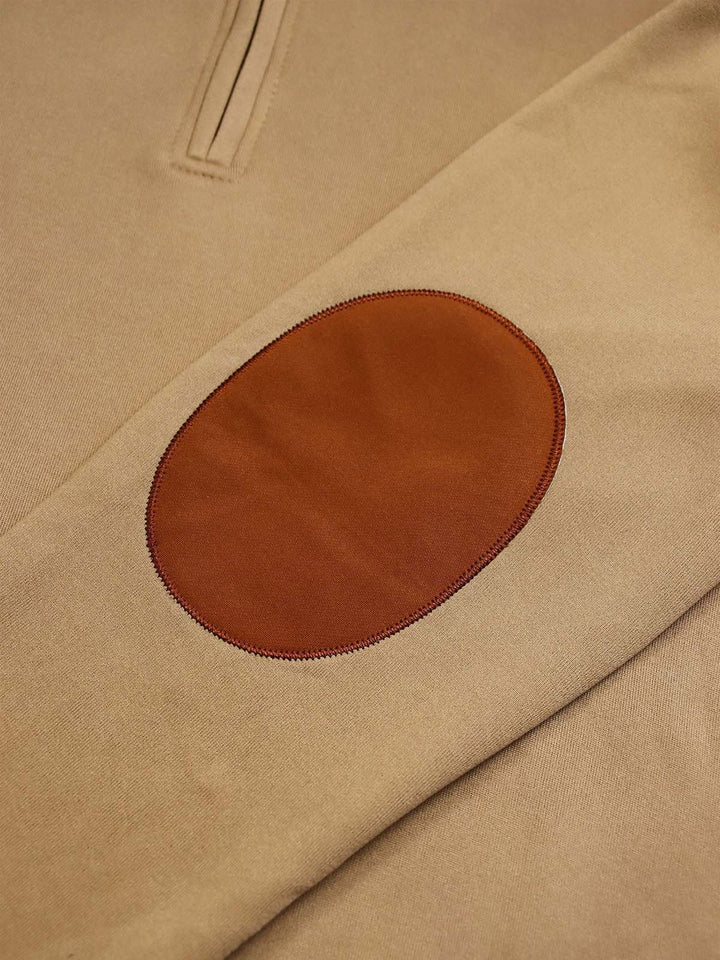 Close up of the orange-brown elbow patch on the khaki quarter zip sleeve