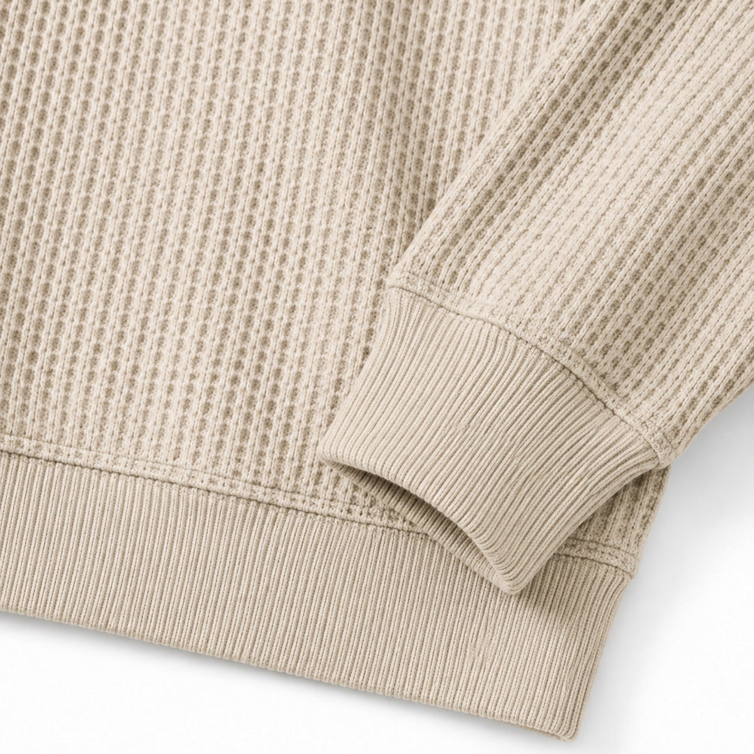 Close-up of the oatmeal waffle knit texture and ribbed cuff