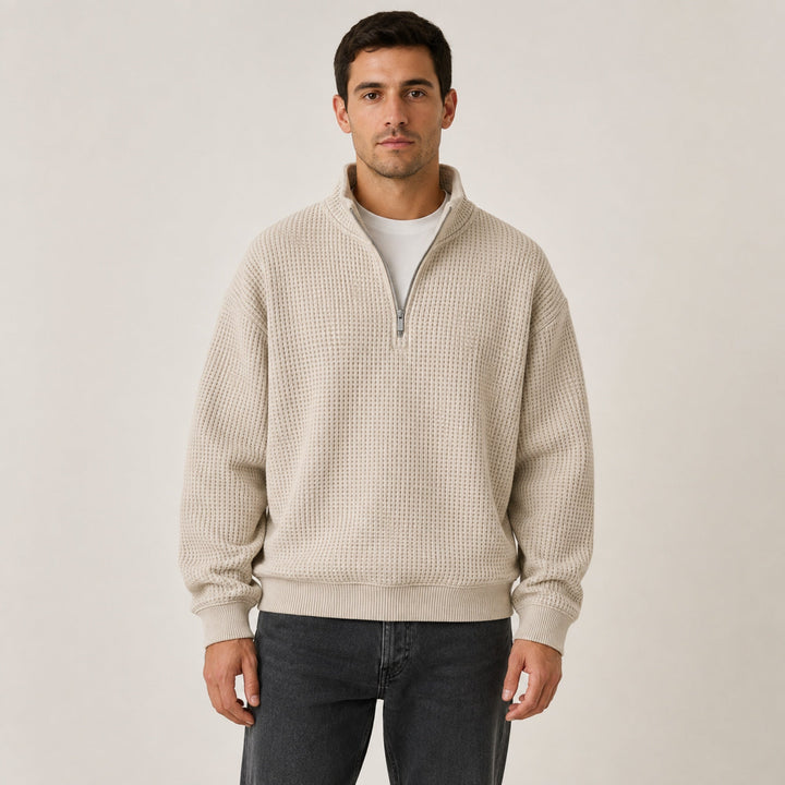 Oatmeal waffle knit quarter zip pullover worn with dark jeans, front view on model