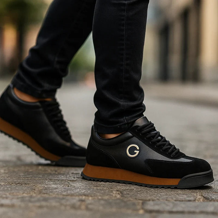 Black retro sneakers with caramel sole worn while walking on a city street