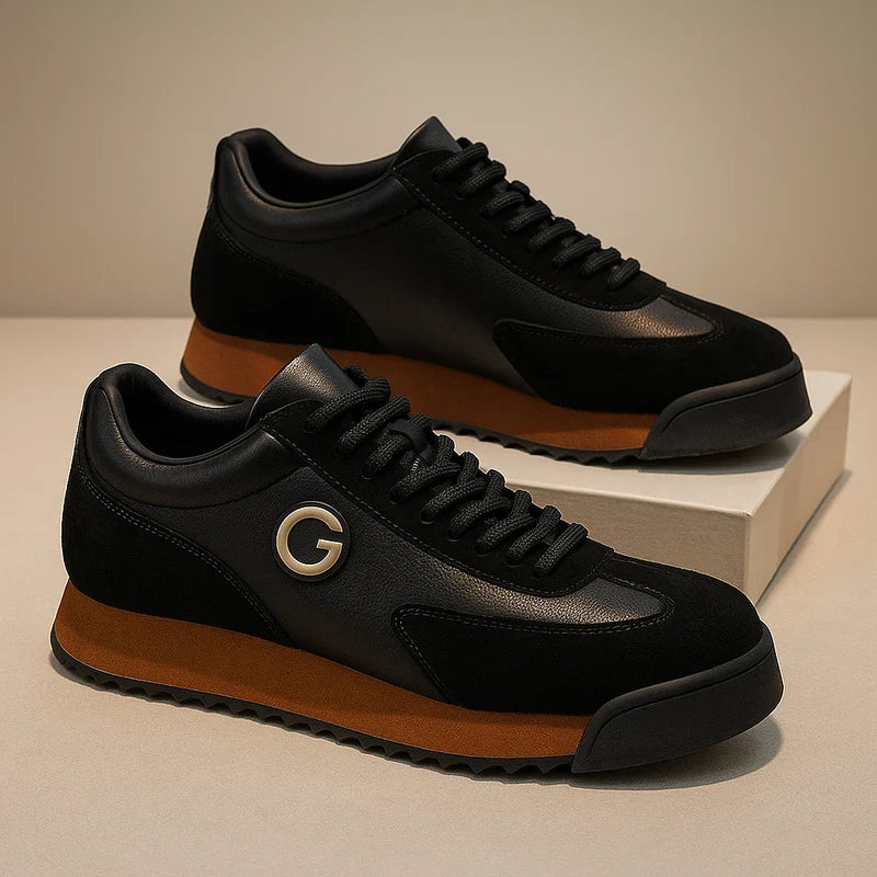 Pair of black retro sneakers with caramel sole and side emblem on a ledge
