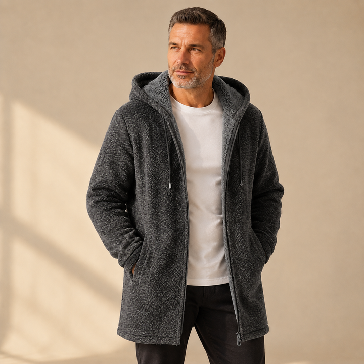 Charcoal longline hooded jacket worn open over a white tee and black pants