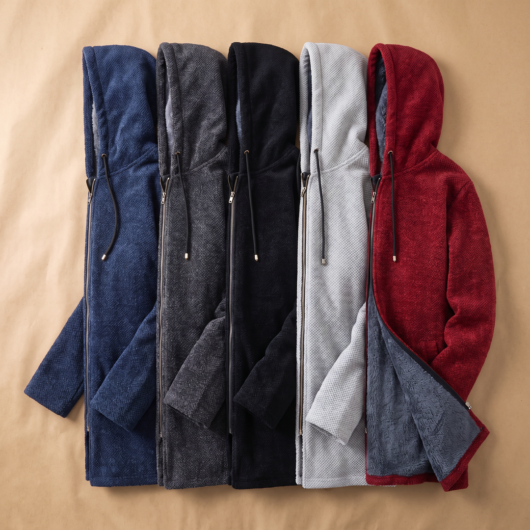 Five longline hooded jackets in different colors folded together on a beige surface
