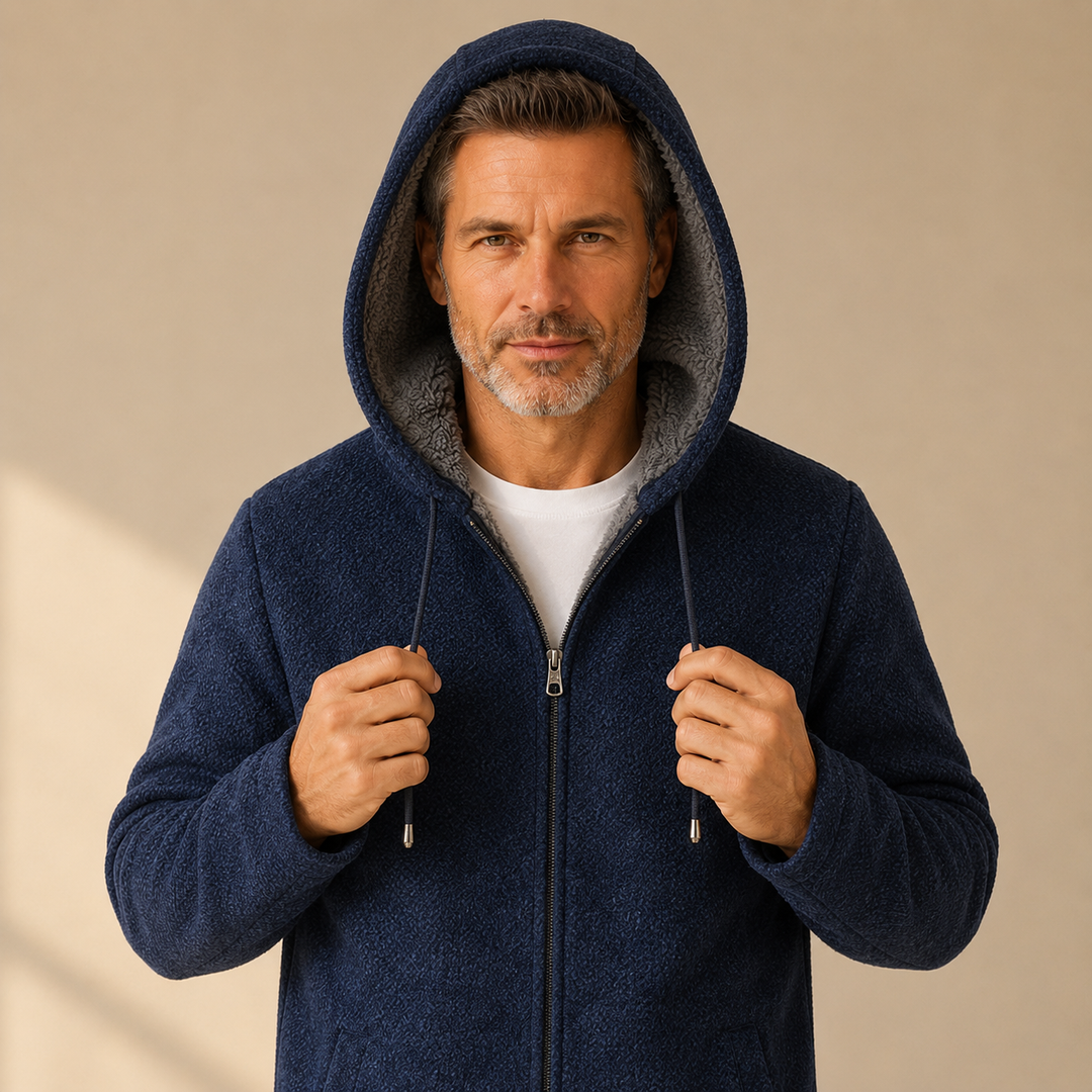 Man holding the hood of the navy zip up jacket with sherpa lining