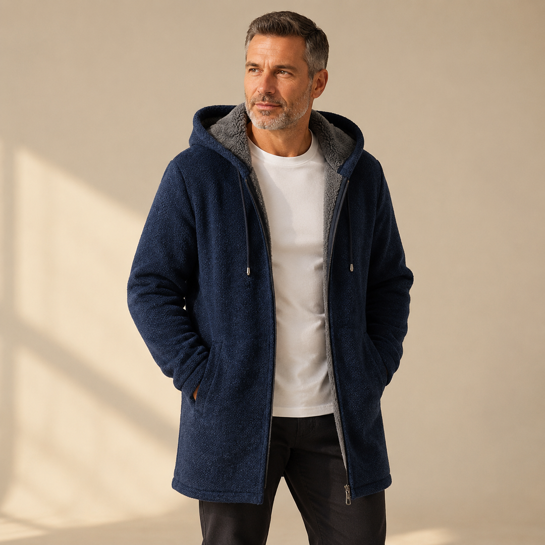 Men's sherpa lined jacket in navy, hooded longline zip up, worn with hands in pockets