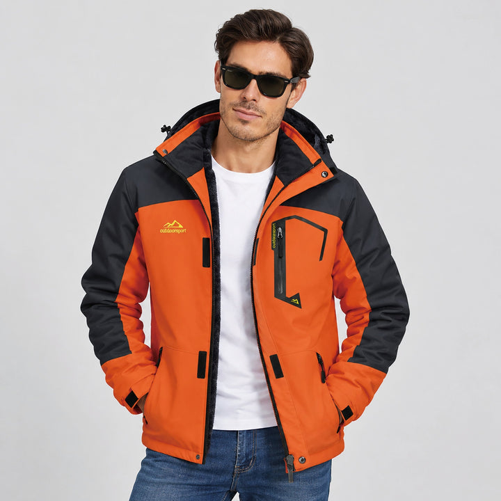 Man wearing the orange snow jacket open over a white tee