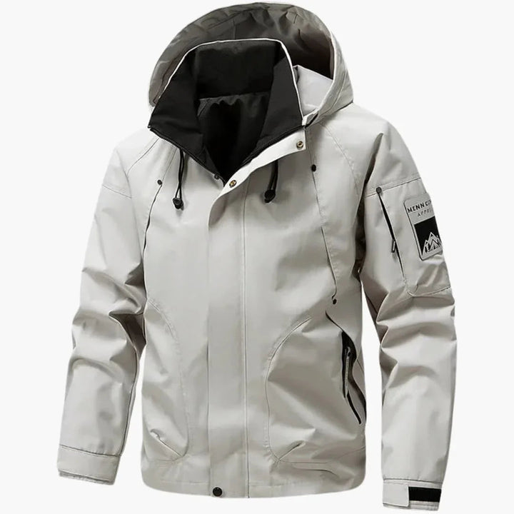 Light gray hooded ski jacket with zip pockets and sleeve badge